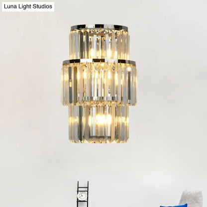 Silver crystal wall sconce with stacked rectangular prisms and warm glow on Tampa Home & Garden Store
