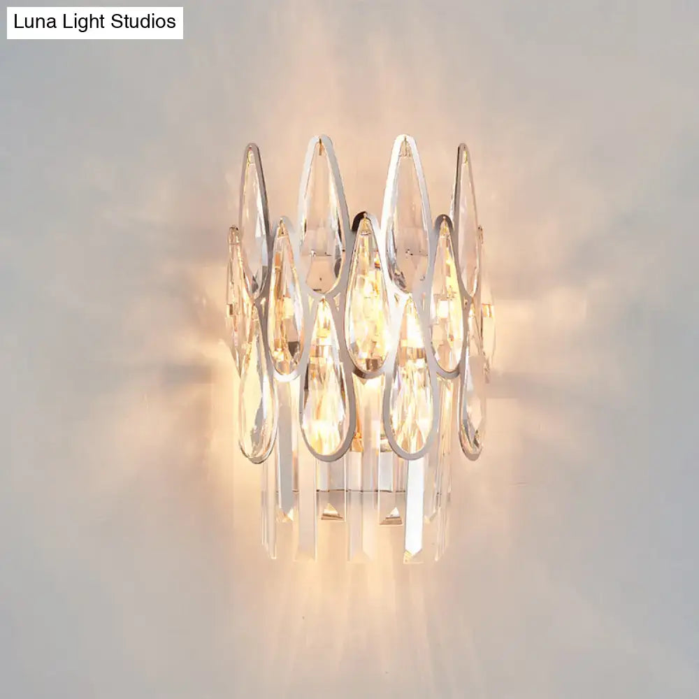 Silver double crystal wall sconce with teardrop prisms and warm glow on Tampa Home & Garden Store