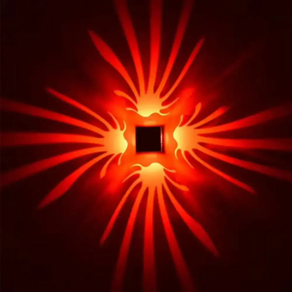 Silver Cube LED Sconce by Decorbites projecting red starburst wall pattern on Tampa Home & Garden Store