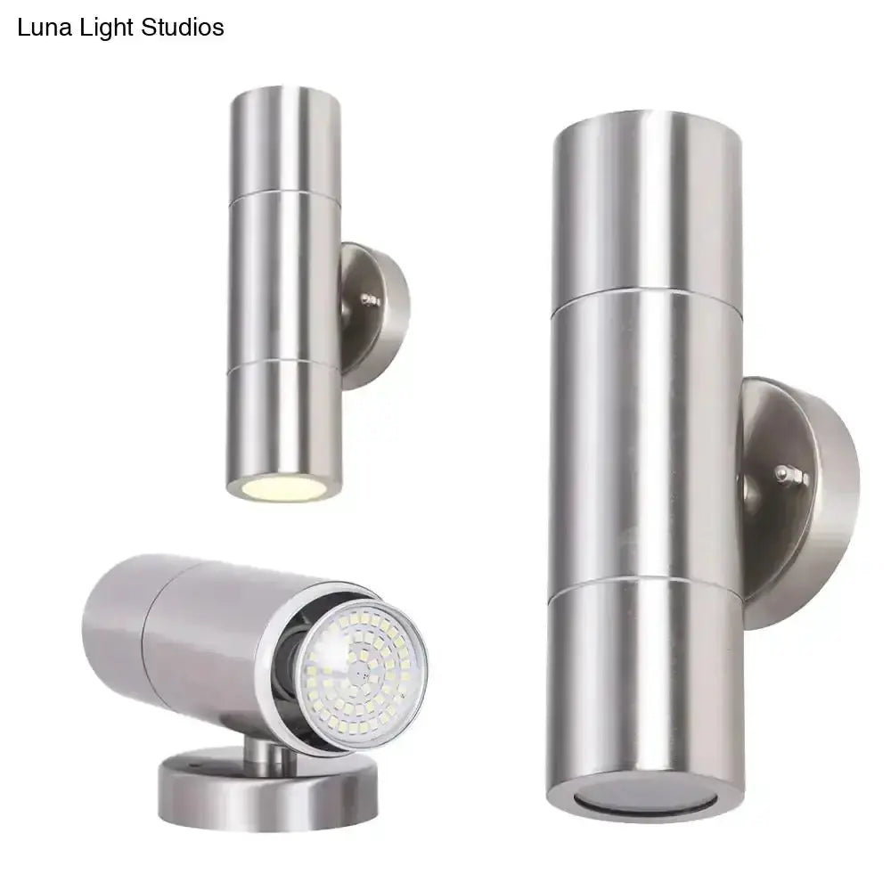 Modern silver cylindrical outdoor wall sconces set with two mounts and a spotlight on Tampa Home & Garden Store