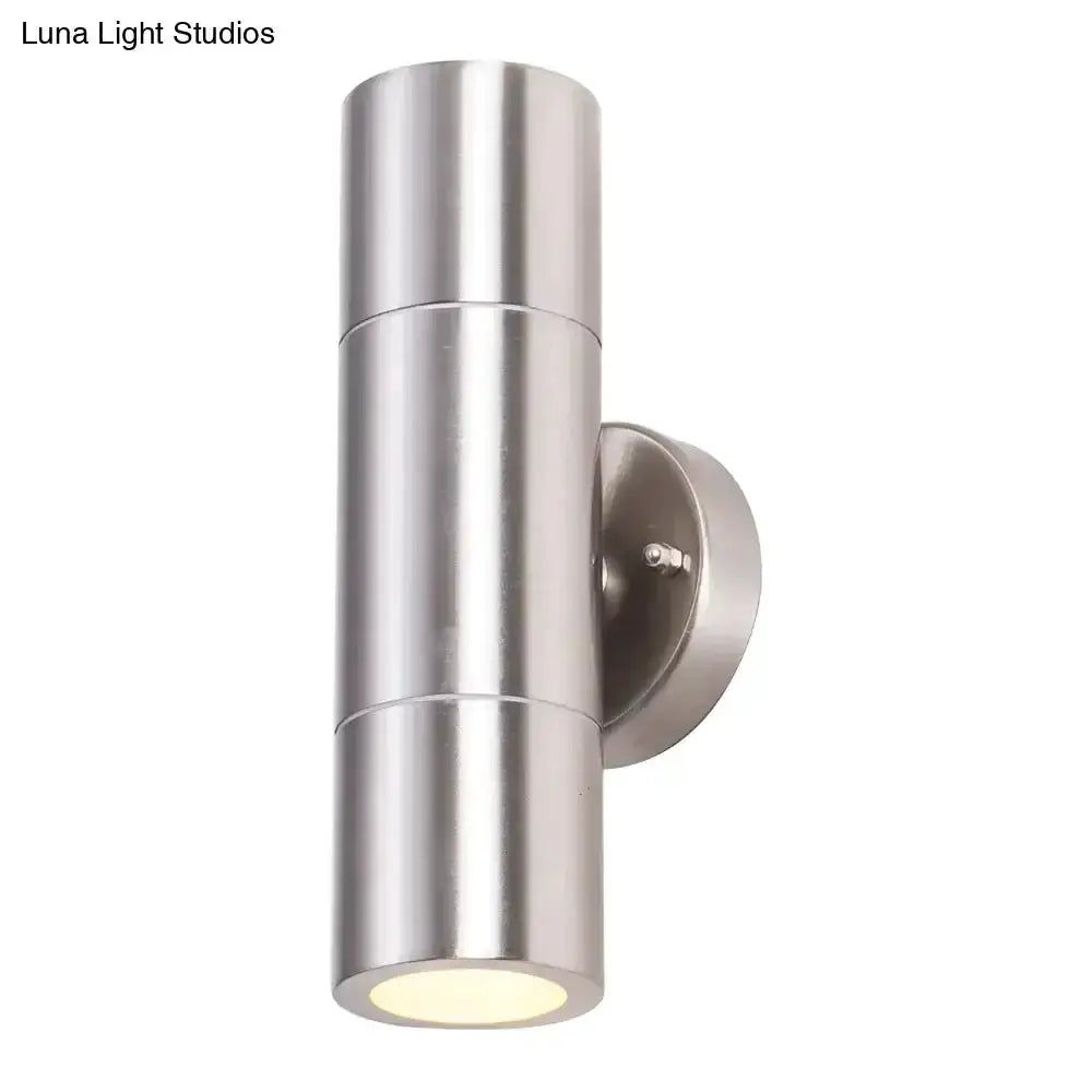 Modern silver cylindrical outdoor wall sconce with single light in stainless steel finish on Tampa Home & Garden Store
