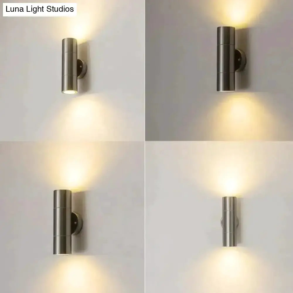 Decorbites silver cylindrical outdoor wall sconces with uplight and downlight; four views on Tampa Home & Garden Store