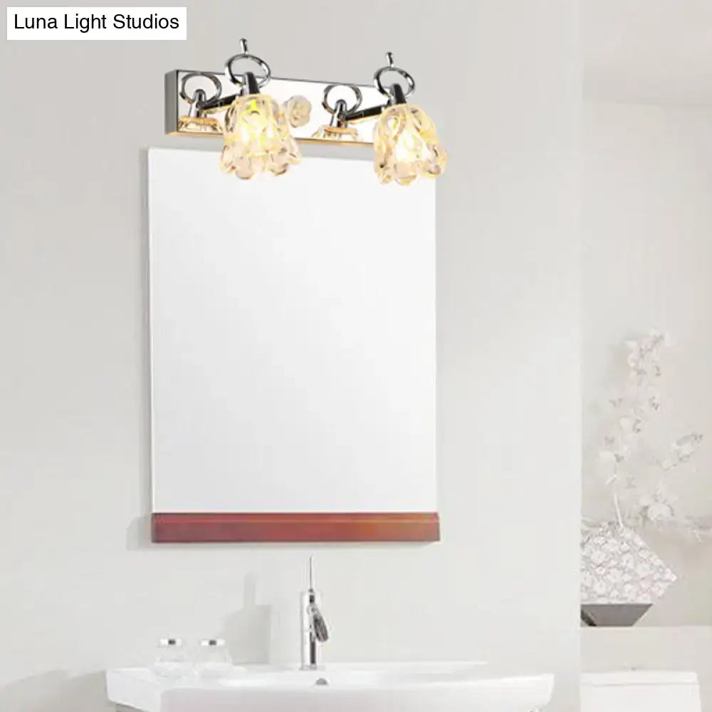 Silver glass flower light fixture with two glass shades over a bathroom mirror Decorbites on Tampa Home & Garden Store