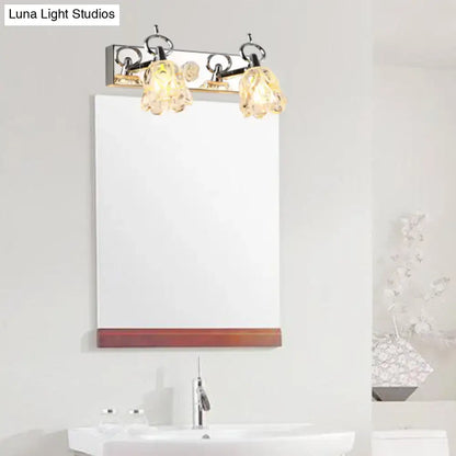Silver glass flower light fixture with two glass shades over a bathroom mirror Decorbites on Tampa Home & Garden Store