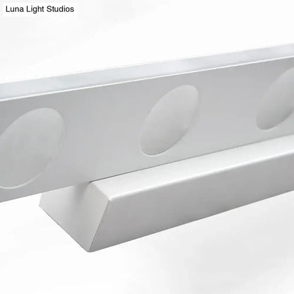Silver oblong LED wall light with circular recessed discs along a slim metal bar on Tampa Home & Garden Store