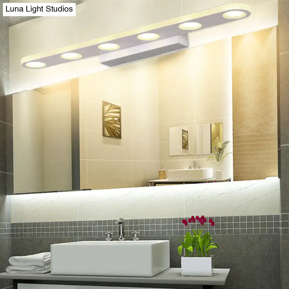 Silver oblong LED wall light by Decorbites above bathroom mirror in modern vanity setup on Tampa Home & Garden Store