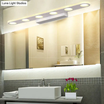 Silver oblong LED wall light by Decorbites above bathroom mirror in modern vanity setup on Tampa Home & Garden Store
