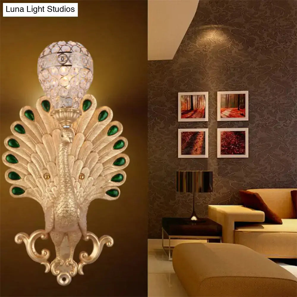 Silver peacock wall sconce with green gemstone accents and crystal shade by Decorbites on Tampa Home & Garden Store