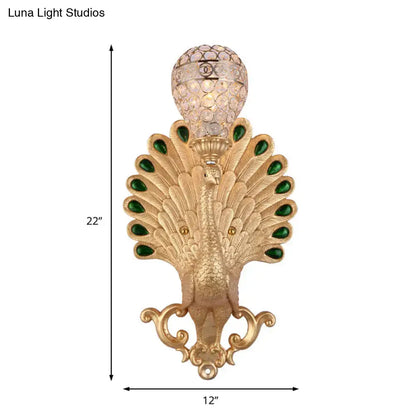 Gold-tone peacock wall sconce with crystal globe and green gemstone accents, 22in tall on Tampa Home & Garden Store