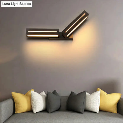 Silver acrylic wall sconce with dual rectangular bars by Decorbites above a gray sofa on Tampa Home & Garden Store