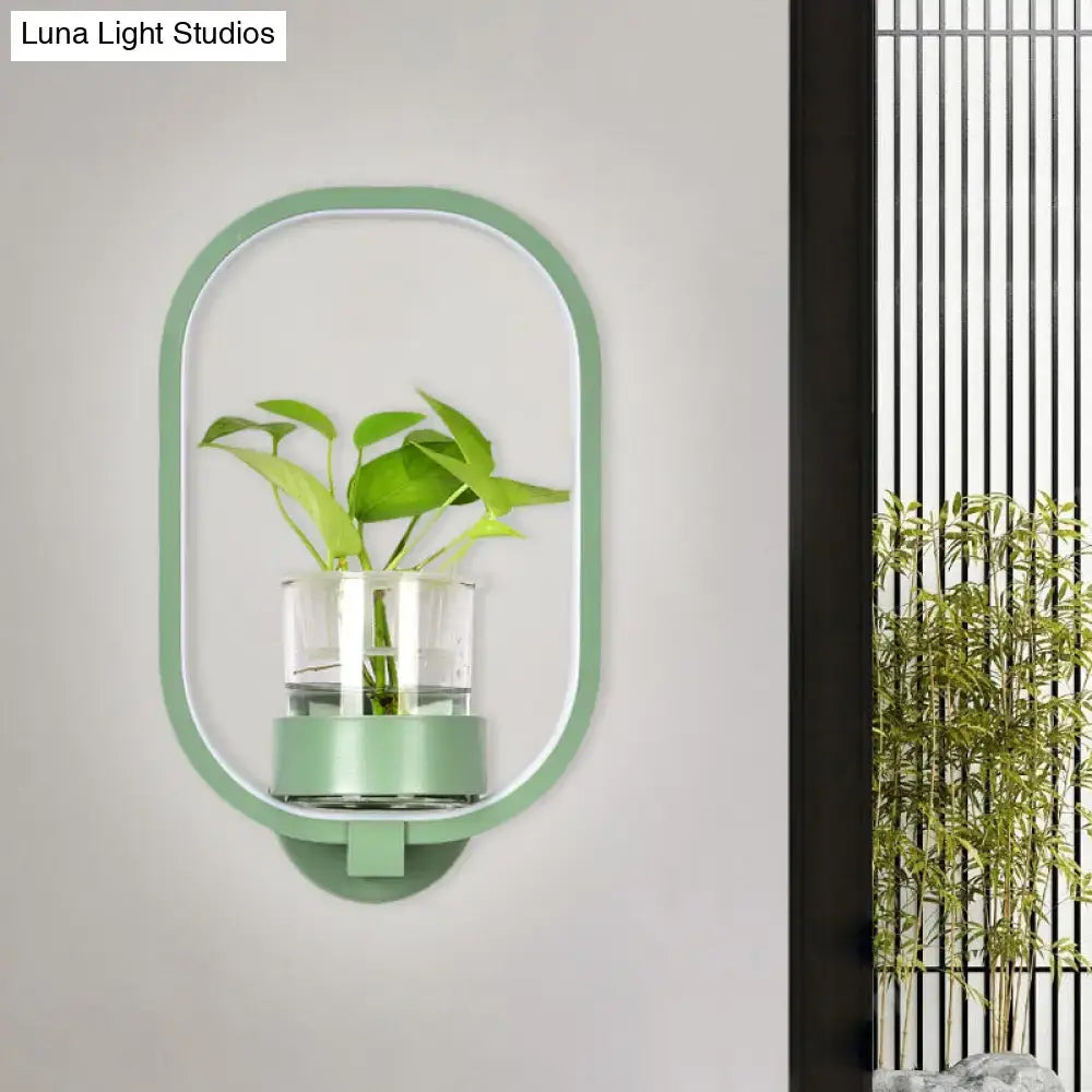 Modern wall light with mint-green metal frame and glass plant pot LED sconce by Decorbites on Tampa Home & Garden Store