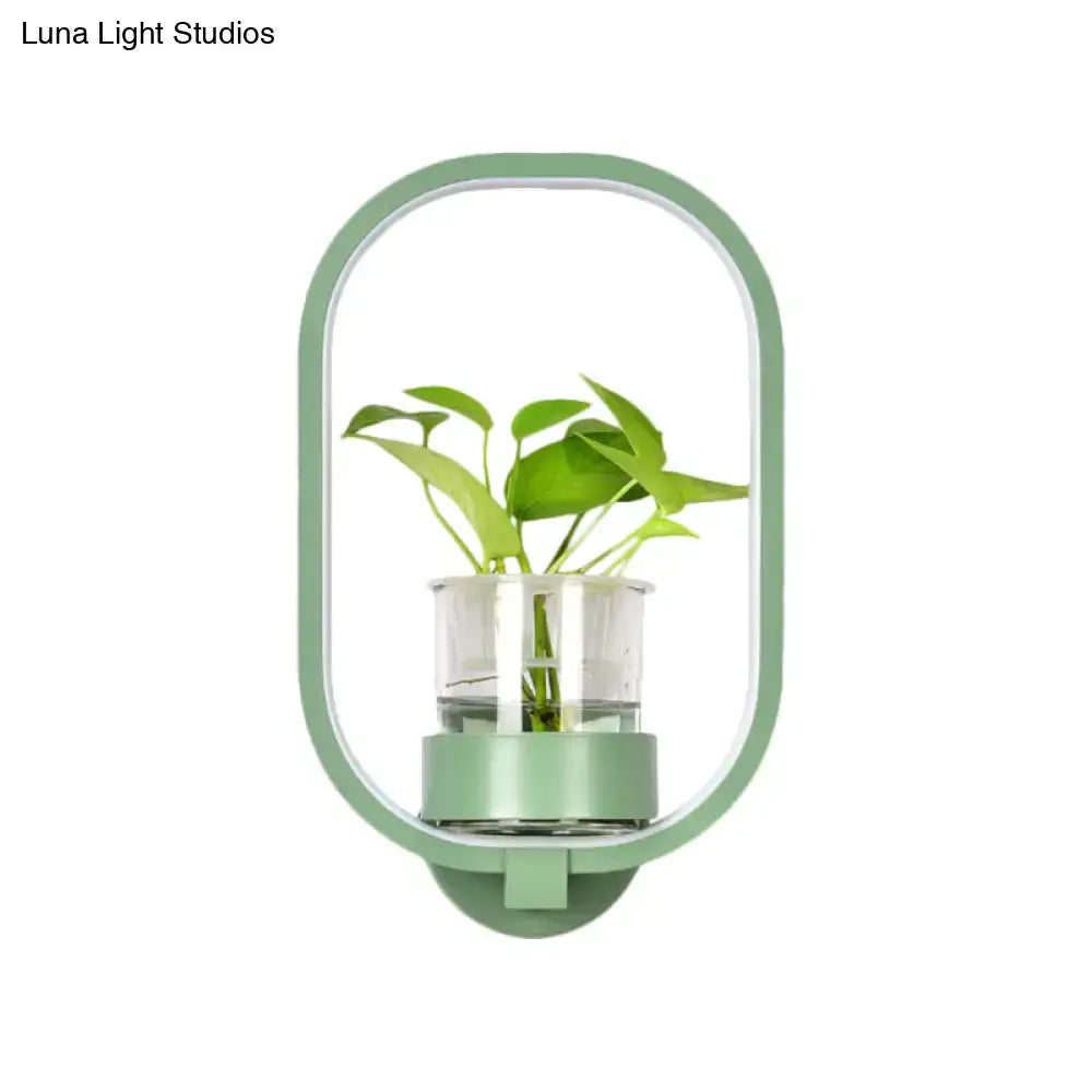 Modern wall light with mint-green frame and glass plant pot LED sconce on Tampa Home & Garden Store