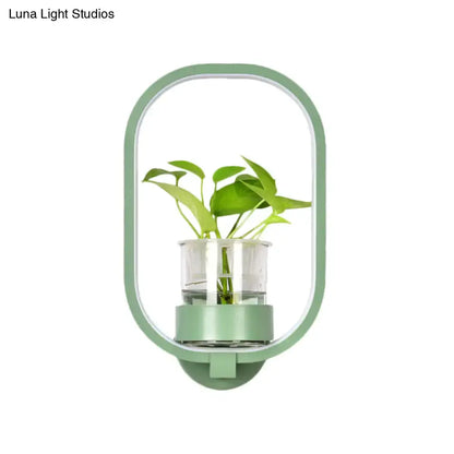 Modern wall light with mint-green frame and glass plant pot LED sconce on Tampa Home & Garden Store