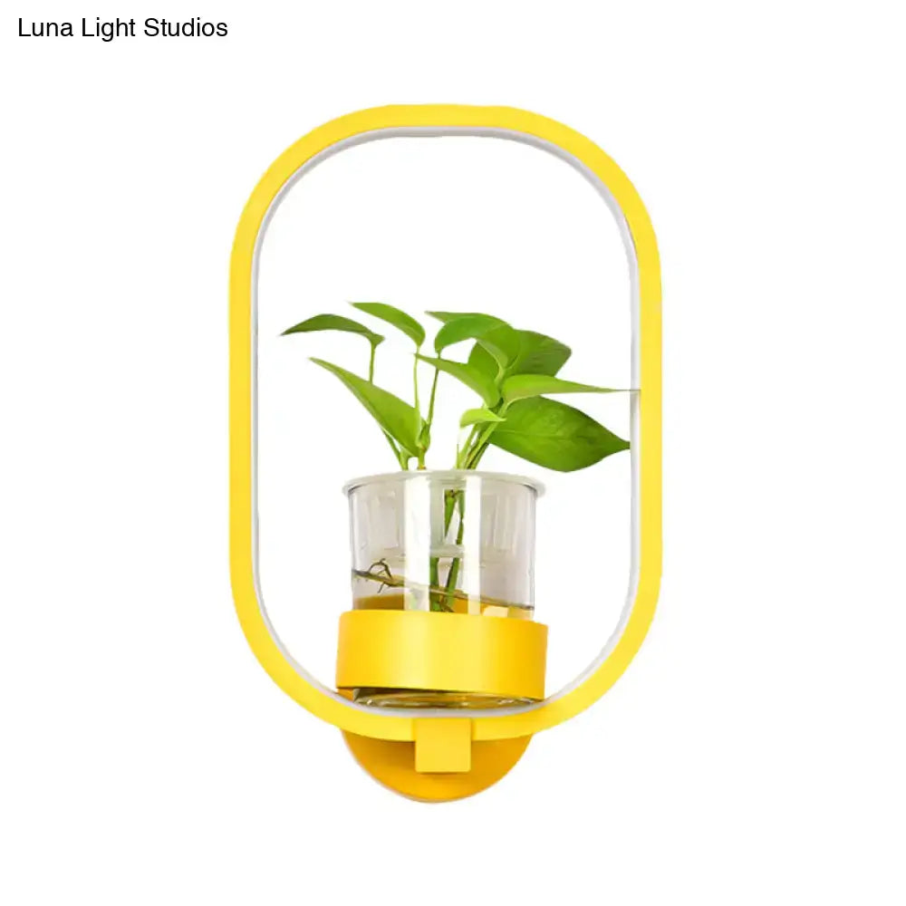 Modern yellow wall light with glass plant pot and green plant on Tampa Home & Garden Store