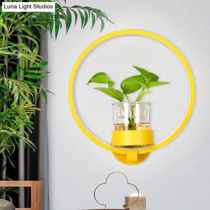 Circular yellow wall sconce by Luna Light Studios with glass planter and plant stems on Tampa Home & Garden Store
