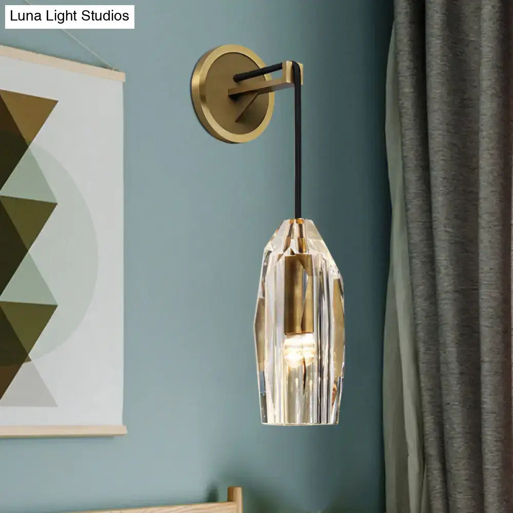Brass crystal wall sconce with faceted glass shade by Decorbites on teal bedroom wall on Tampa Home & Garden Store