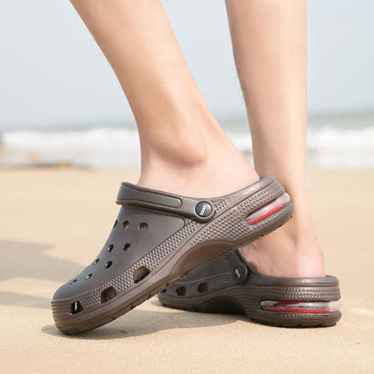 Stevvex unisex brown slip on clogs with perforated upper and strap on sandy beach on Tampa Home & Garden Store