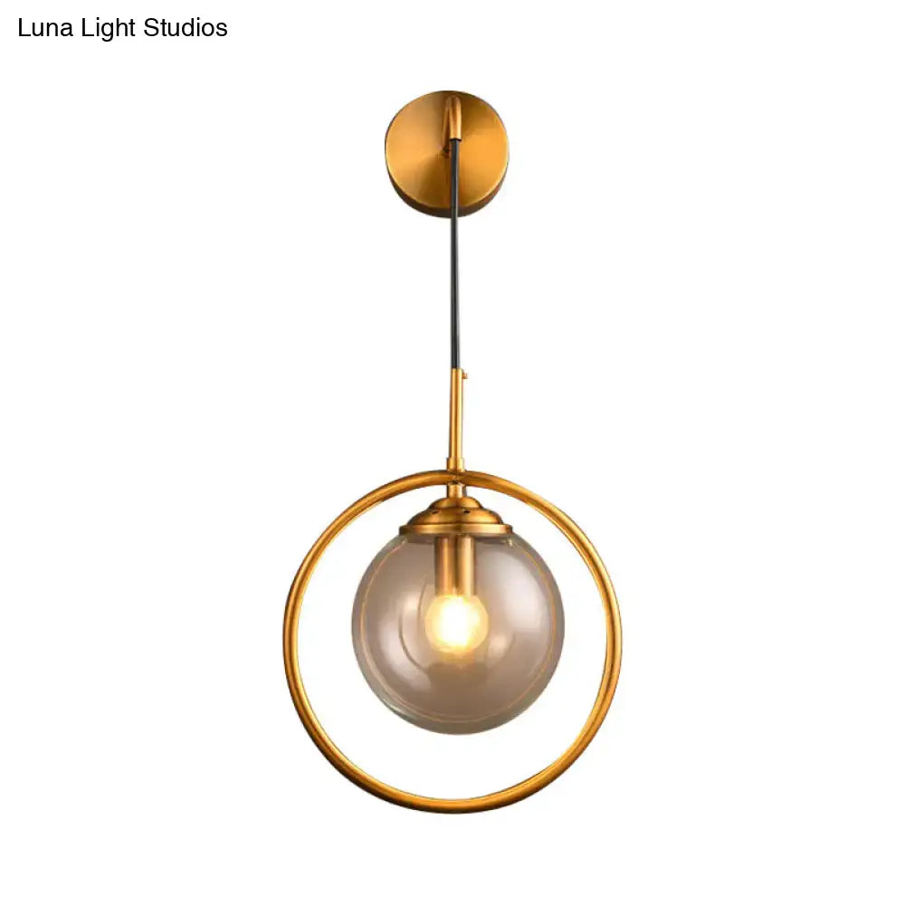 Gray Glass Globe Sconce by Decorbites with a gold circular ring frame on Tampa Home & Garden Store