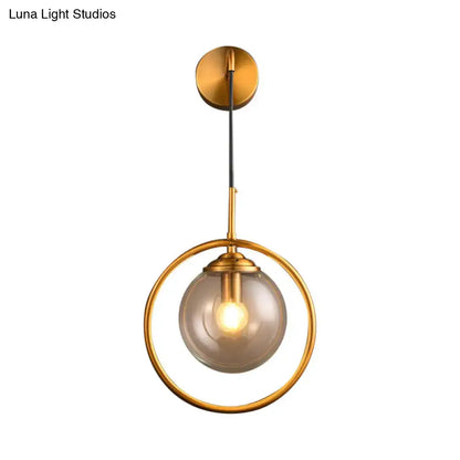 Gray Glass Globe Sconce by Decorbites with a gold circular ring frame on Tampa Home & Garden Store