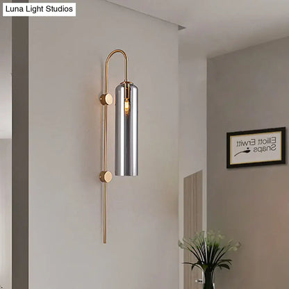 Gray glass cylindrical wall sconce with brass frame and vertical stem Decorbites on Tampa Home & Garden Store