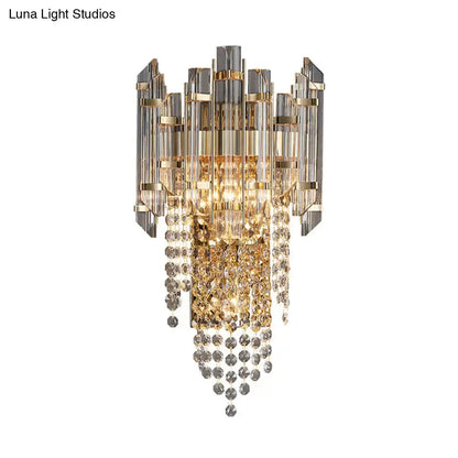 Gray crystal wall sconce with gold-tone frame and hanging crystal strands on Tampa Home & Garden Store