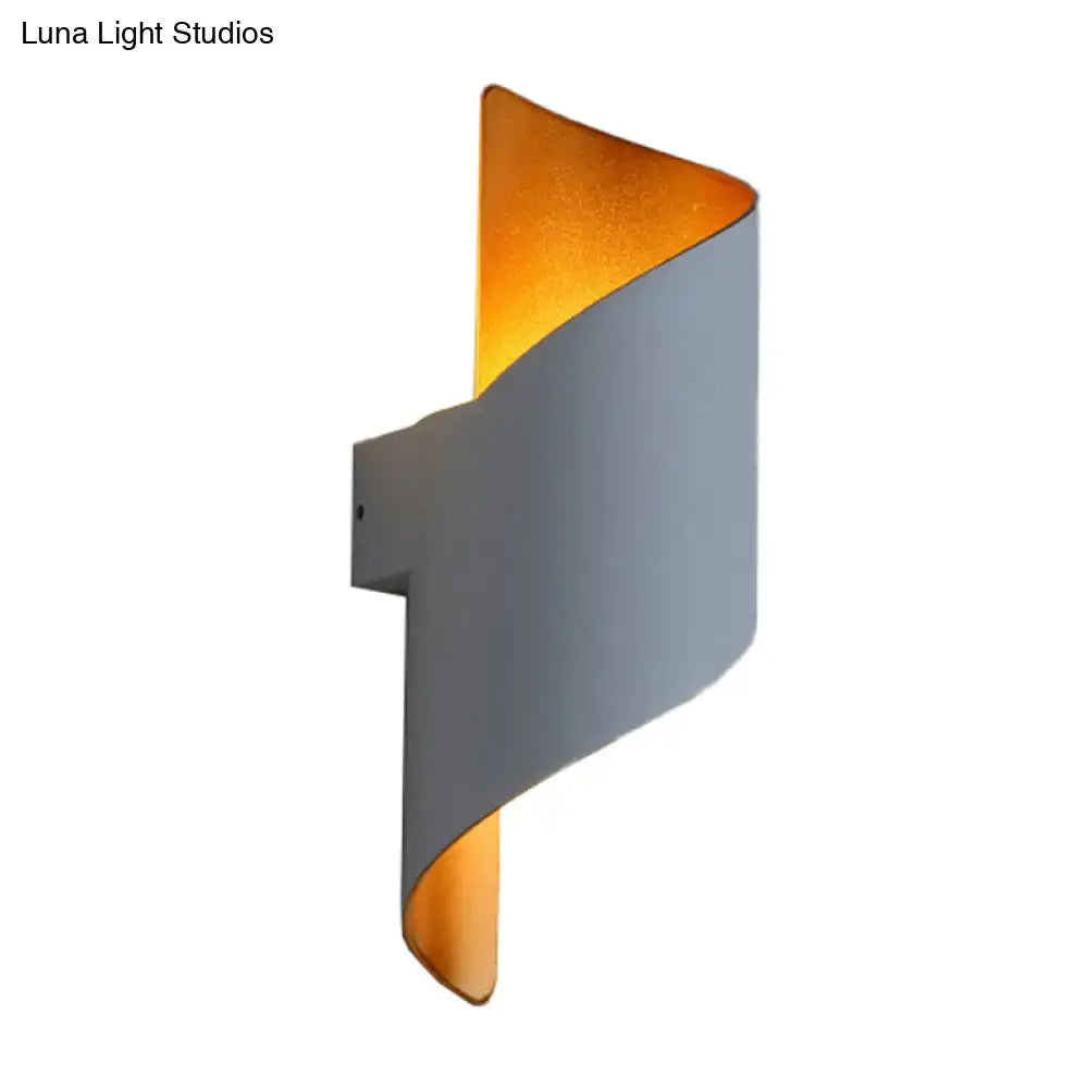 White gold spiral sconce by Decorbites; gray curved wall light with warm gold interior on Tampa Home & Garden Store