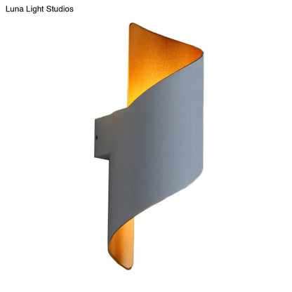White gold spiral sconce by Decorbites; gray curved wall light with warm gold interior on Tampa Home & Garden Store