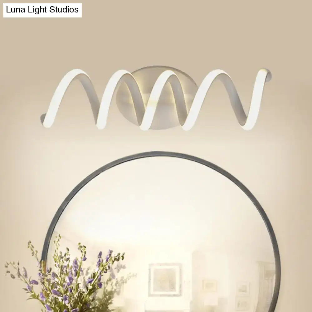 Decorbites modern spiral white LED wall light sconce for bathroom above a round mirror on Tampa Home & Garden Store