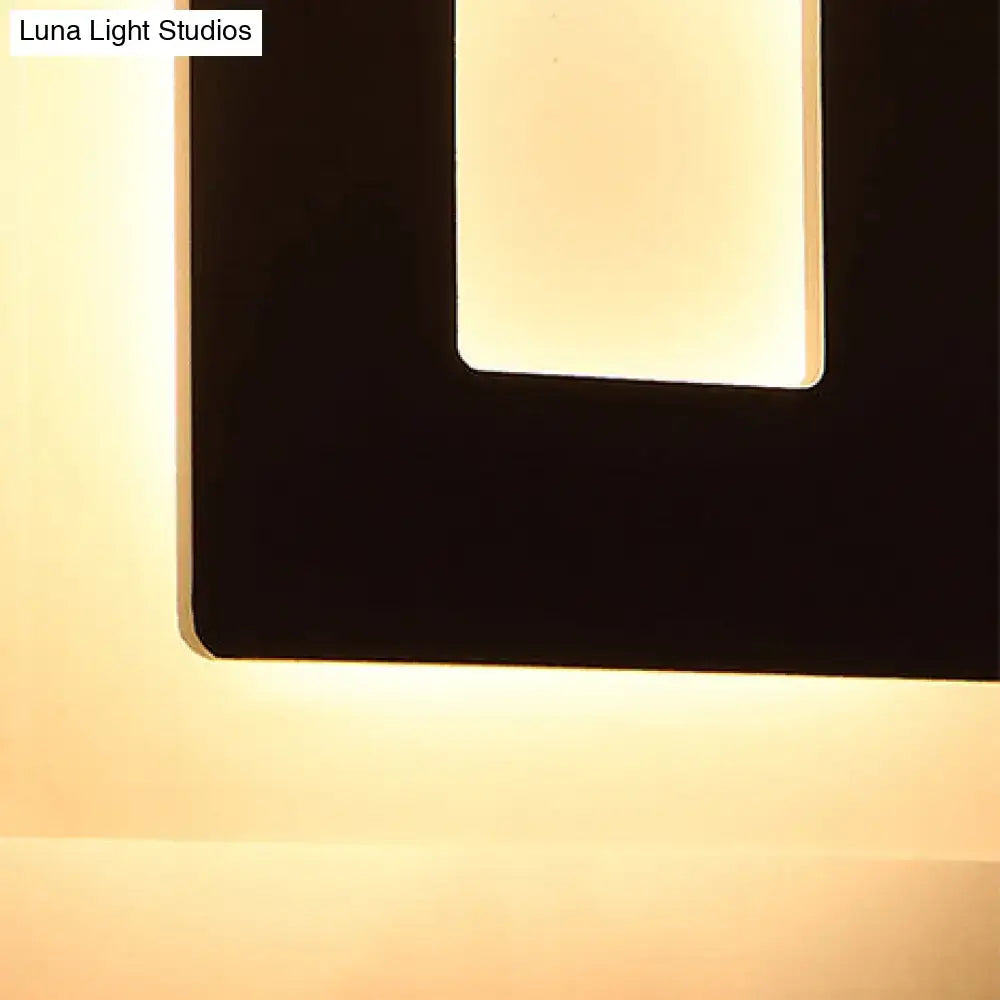 Decorbites black acrylic square-shaped wall sconce with warm backlit glow on Tampa Home & Garden Store