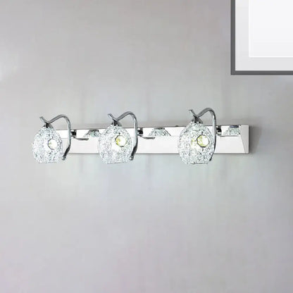 Stainless steel vanity light with three crackle glass globe shades on a chrome bar on Tampa Home & Garden Store