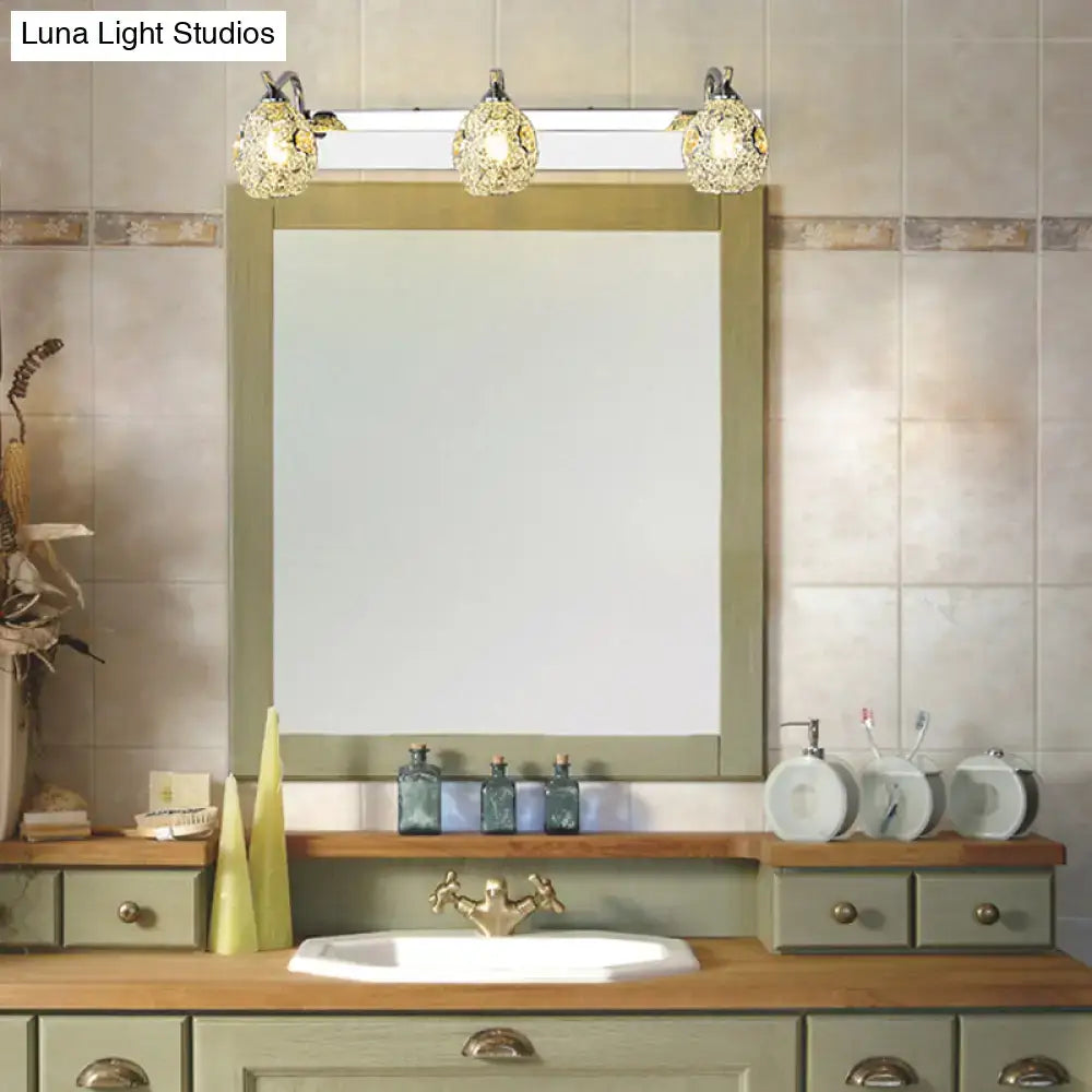 Stainless steel vanity light with three crystal globe bulbs over a bathroom mirror on Tampa Home & Garden Store