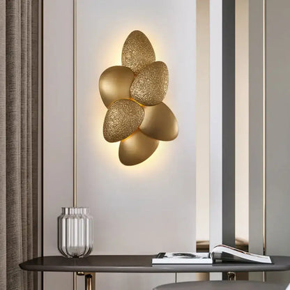 Decorbites Gold Squama Wall Sconce with petal-shaped brass leaves and warm backlight on Tampa Home & Garden Store