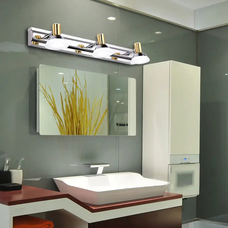 Chrome gold vanity light fixture by Decorbites with frosted glass shades above modern sink on Tampa Home & Garden Store
