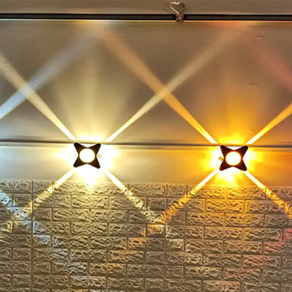 Black Petals Wall Sconce pair with cross-shaped petals, warm white light on brick wall on Tampa Home & Garden Store