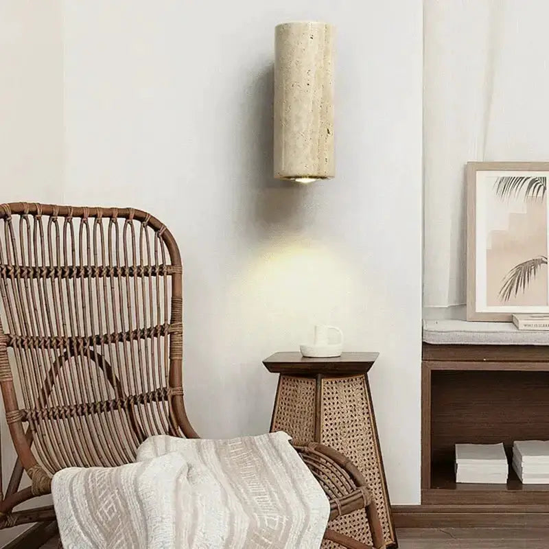 Modern stone and wood wall lamp beige cylinder Decorbites on wall above woven side table on Tampa Home & Garden Store