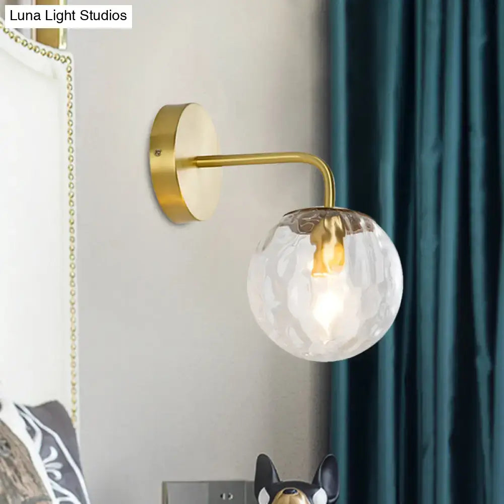 Gold hammered glass living room sconce by Decorbites, brass finish with round glass shade on Tampa Home & Garden Store