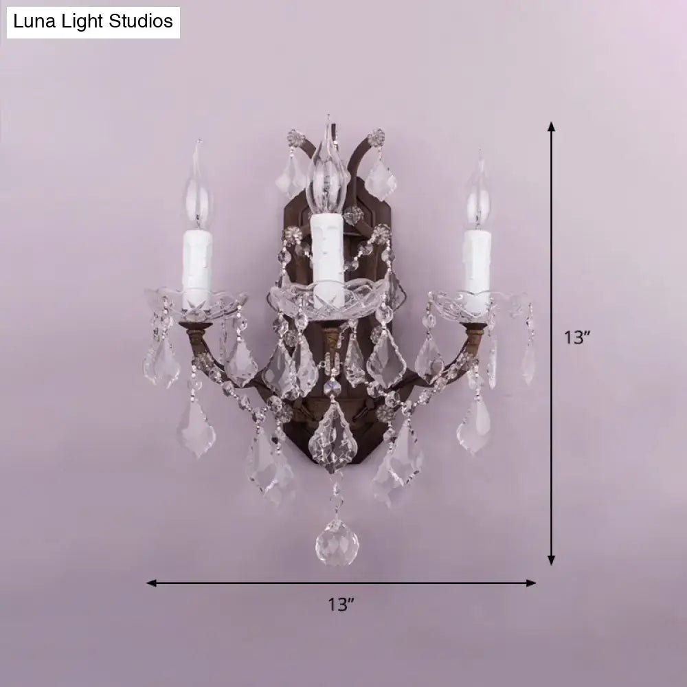 White Rust Crystal Sconce with three candle bulbs and hanging prisms on bronze mount on Tampa Home & Garden Store