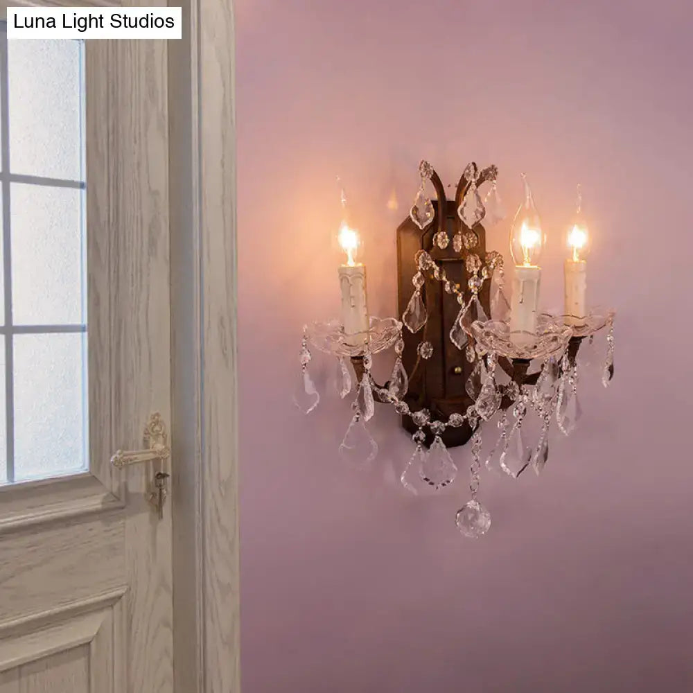 White Rust Crystal Sconce by Decorbites with crystal droplets and dual candle bulbs on pink wall on Tampa Home & Garden Store