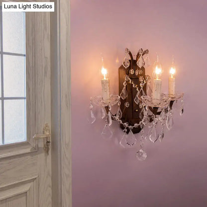 White Rust Crystal Sconce by Decorbites with crystal droplets and dual candle bulbs on pink wall on Tampa Home & Garden Store