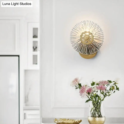 Gold sunburst metal wall sconce with radial spokes mounted on white wall on Tampa Home & Garden Store