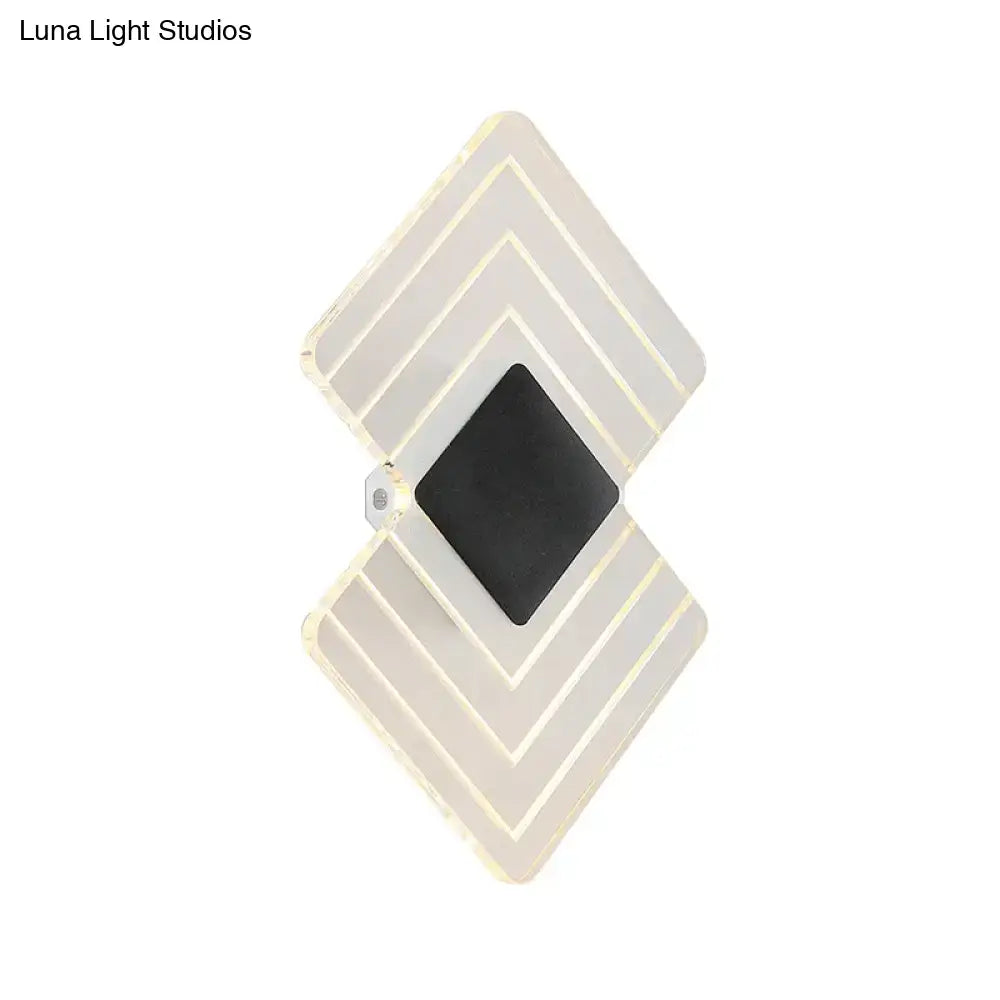 LED sconce with silver geometric double-diamond frame and black center on Tampa Home & Garden Store