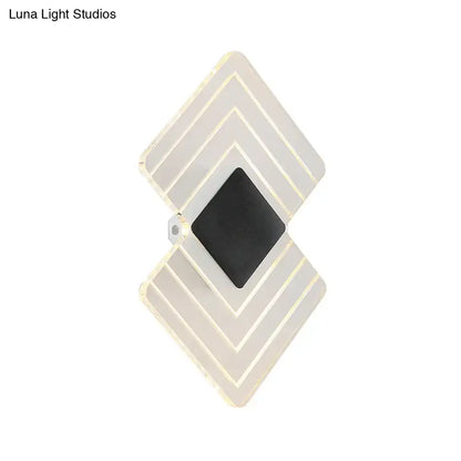 LED sconce with silver geometric double-diamond frame and black center on Tampa Home & Garden Store