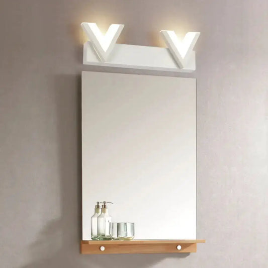 Modern v-shaped white LED vanity light with warm glow above bathroom mirror by Decorbites on Tampa Home & Garden Store