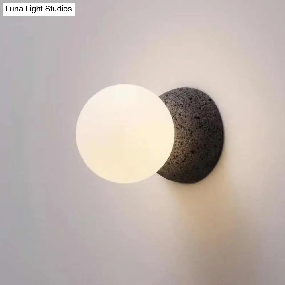 Stone Glass Wall Lamp with frosted glass globe on a dark stone wall mount by Decorbites on Tampa Home & Garden Store