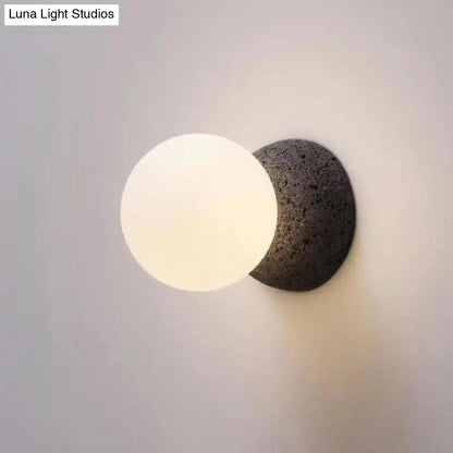 Stone Glass Wall Lamp with frosted glass globe on a dark stone wall mount by Decorbites on Tampa Home & Garden Store