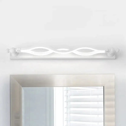 Modern wavy white twist acrylic vanity sconce by Decorbites over a silver mirror on Tampa Home & Garden Store