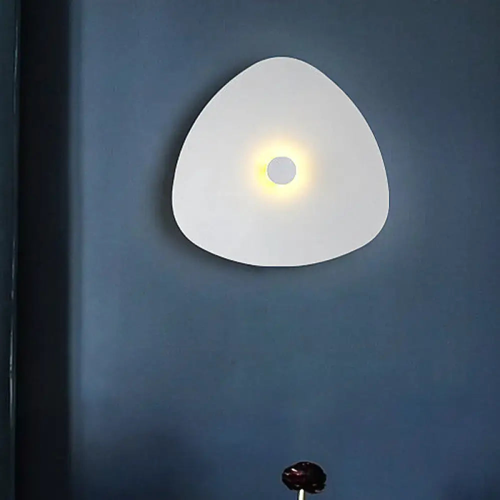 White flaky acrylic sconce by Decorbites, glossy triangular wall light with warm glow on wall on Tampa Home & Garden Store