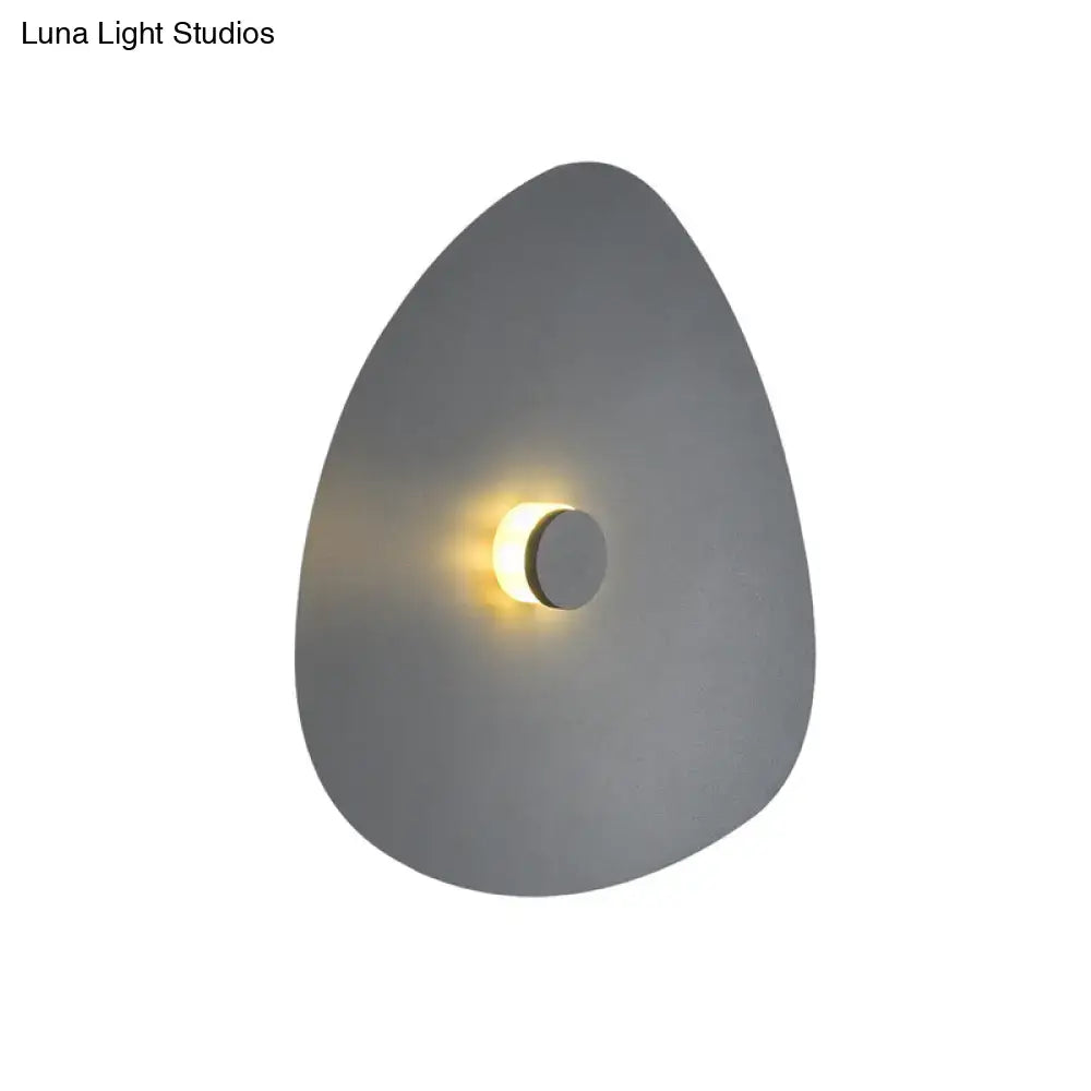 White flaky acrylic sconce with triangular plate and warm glow on Tampa Home & Garden Store