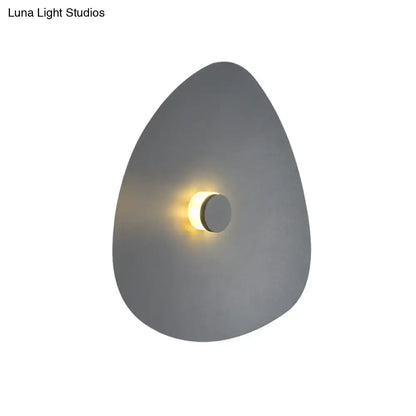 White flaky acrylic sconce with triangular plate and warm glow on Tampa Home & Garden Store