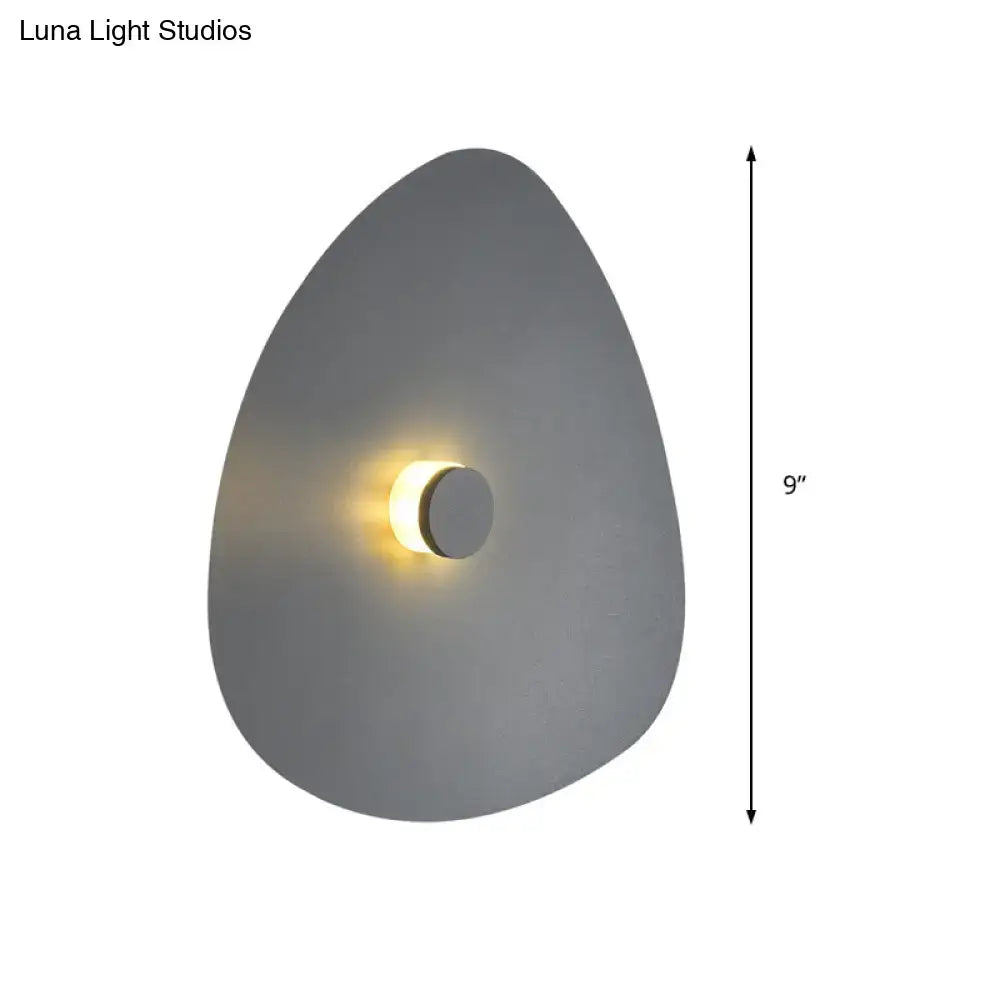 White flaky acrylic sconce with glossy finish and small centered warm light, 9 inches tall on Tampa Home & Garden Store